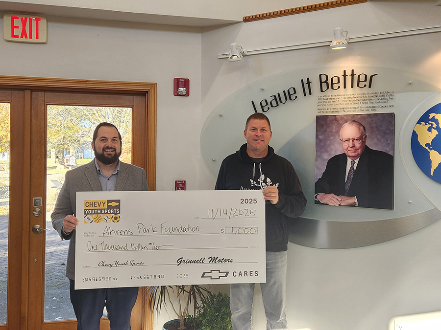 grinnell motorsports presenting donation check to Chad Nath